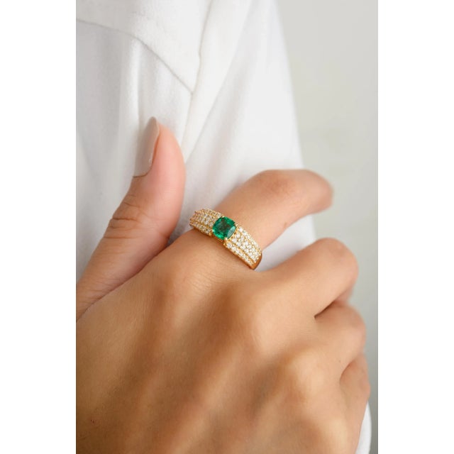 Experience timeless elegance with our 18K cushion cut center stone emerald wedding ring, adorned with chunky diamonds....