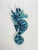 A blue glazed ceramic wall decoration, France, 1970s, depicting a stylized seahorse with expressive and textured forms....