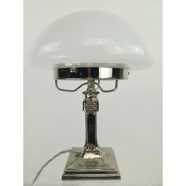 Chrome-plated brass table lamp, massive. Opal overfong glass. The lamp gives a cozy non-dazzling light. Wired according to...