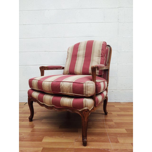 A gorgeous pair of French Provincial Louis XV style chairs. Made by Baker Furniture Circa 1980s. Frame is carved walnut,...