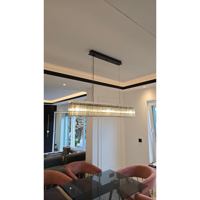 This elegant linear chandelier, crafted in our own workshop, combines contemporary design with sophisticated lighting. The...