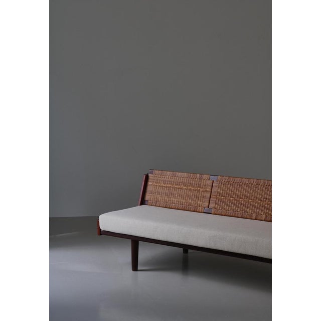 Designed by Hans Wegner for GETAMA this amazing convertible daybed / sofa features a beautifully patinated teakwood frame...