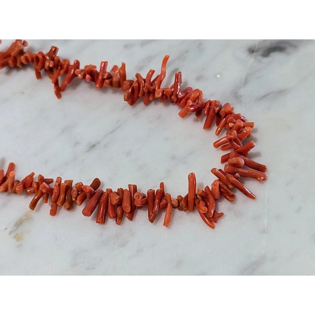 30" necklace with delicate looking coral branches. The age could be older. Purchased in an unused condition. Some call...