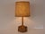 Very unique and rare vintage brutalist table lamp made of a cluster of 6 wooden logs carved into a triangle at the base....