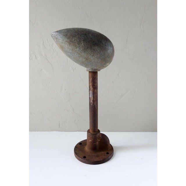 Vintage heavy metal sculptural tear drop shape on cast iron stand. Possibly a mold of some sort. Overall patina and...