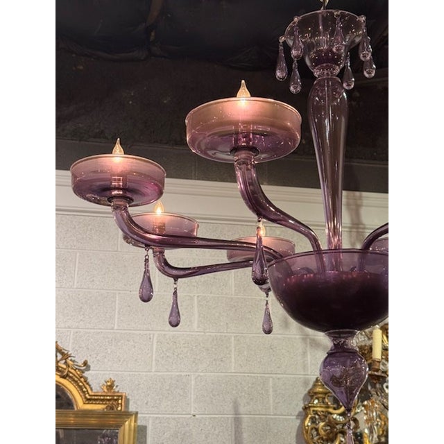 The product is a decorative 8 arm lavender Murano chandelier, which adds a stylish touch to any room. Made with intricate...