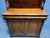 Mahogany sideboard opening with two doors and two drawers, the upper part is carved with swan neck consoles, the doors are...