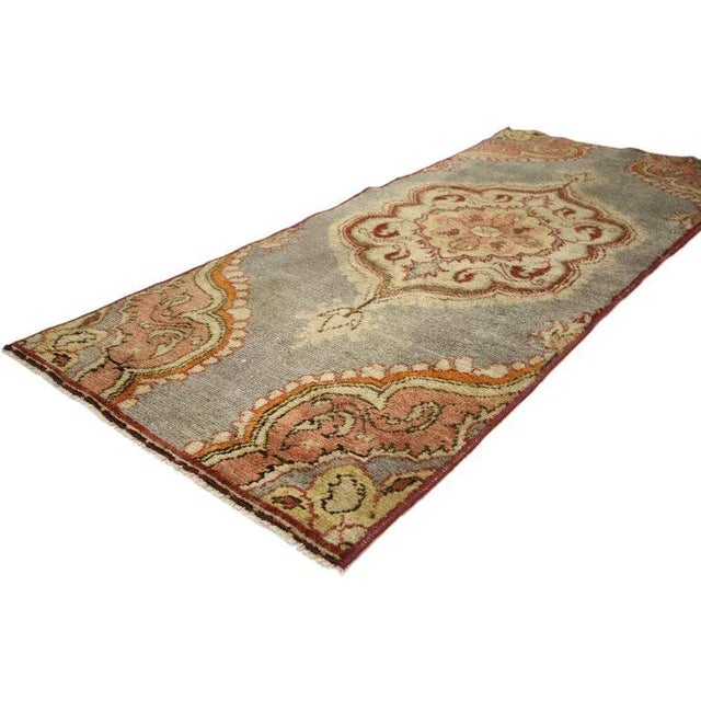 Emanating classic style with Jacobean flair this vintage Turkish Oushak accent rug features a lobed medallion set on an...