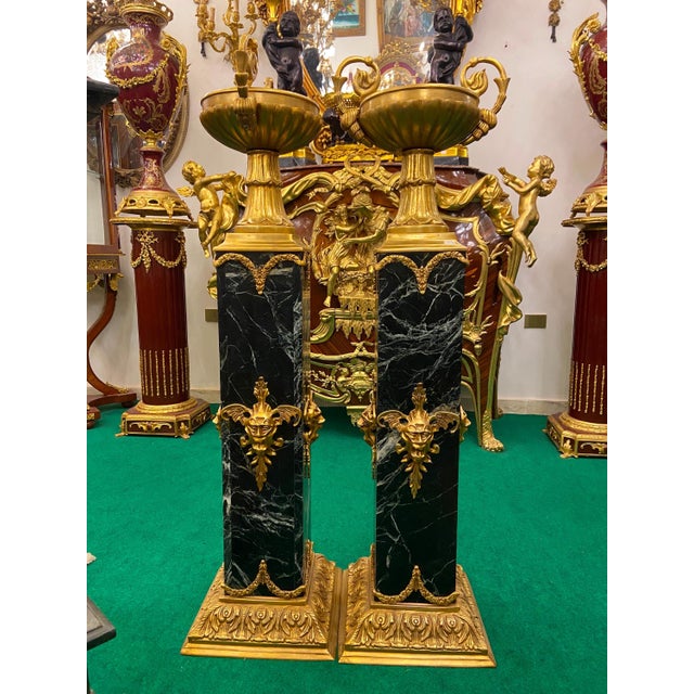 Make a grand statement with this magnificent pair of French-inspired Empire style jardinieres. Featuring dramatic black...