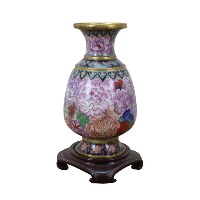 Vintage Chinese cloisonné enamel vase with a chrysanthemum, butterfly and tulip motif. Includes wooden stand. Dimensions:...