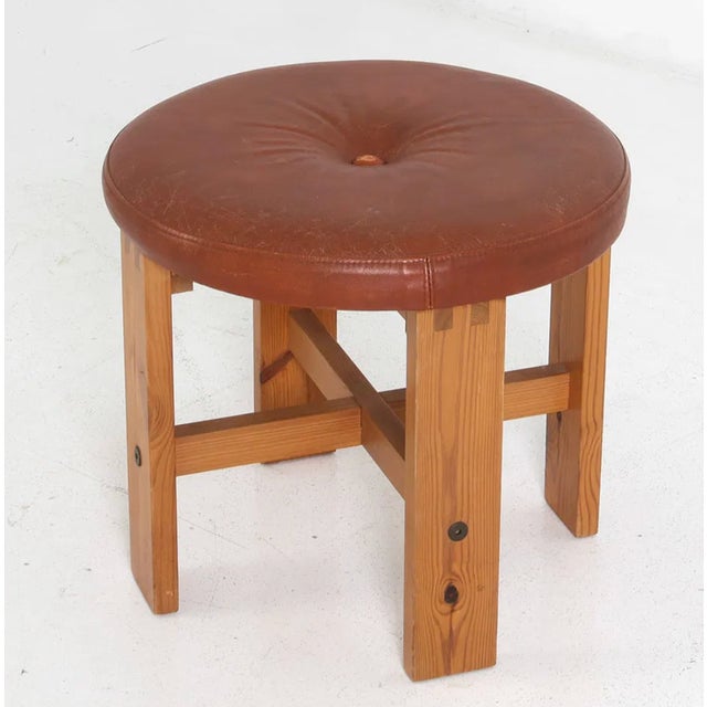 Lovely pine and leather upholstered stool in the manner of Kai Kristianssen. Sweden, circa 1970s. Dimensions: H 16.5" x...
