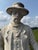 A monumental hand-cast concrete sculpture of a Western gunslinger, standing 80 inches tall. This is a heavy, solid piece,...
