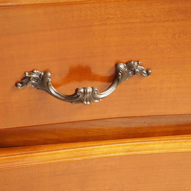 A small Louis XV-style chest of drawers, manufactured in the 20th century as a reproduction of historical models. Resting...