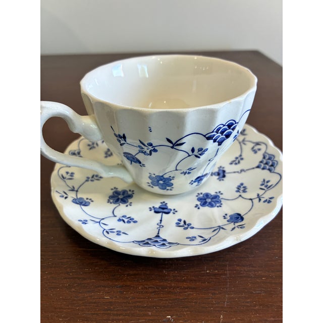 A classic English teacup and saucer set in the sought-after Finlandia pattern by Myott. Featuring a timeless blue and...