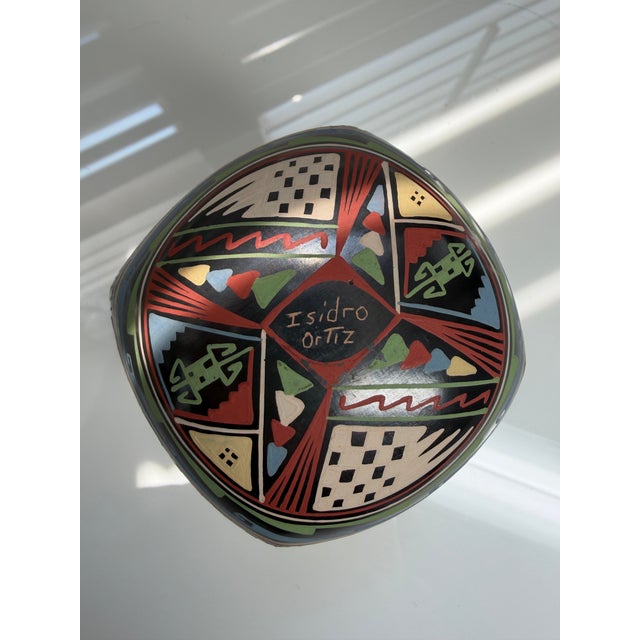 A striking hand-coiled Mata Ortiz pottery vessel, signed by potter Isidro Ortiz, sourced from West Southwest, a specialty...