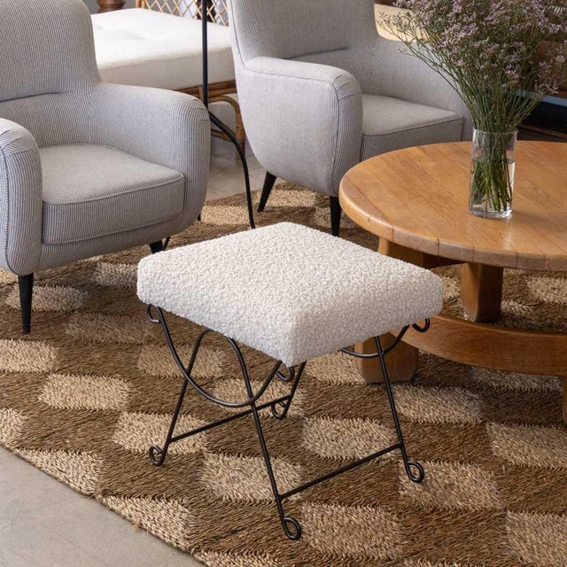 Iron stool with beautiful curved and looped base with matte black painted finish. Rectangular cushioned seat upholstered...