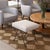 Iron stool with beautiful curved and looped base with matte black painted finish. Rectangular cushioned seat upholstered...