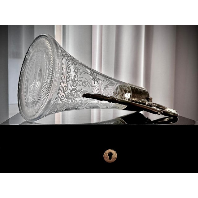 English Victorian claret jug with finely etched glass body and ornate silver-plated mounts. The tall flared form is...