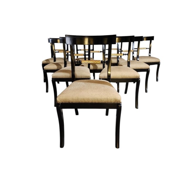A set of 10 custom-made Regency/Greek Revival Klismos saber leg dining chairs with a highly polished ebonized finish,...