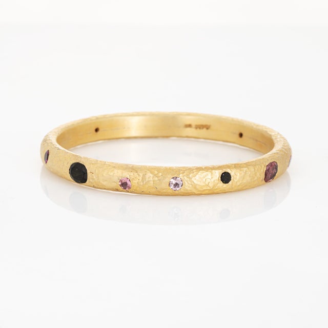 Stylish contemporary gemstone bangle bracelet crafted in sterling silver with a 24k yellow gold plate overlay. Natural...