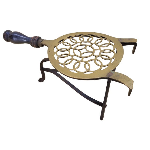 Authentic Victorian English brass and iron adjustable open-fire trivet, featuring a circular top with inner ring design...
