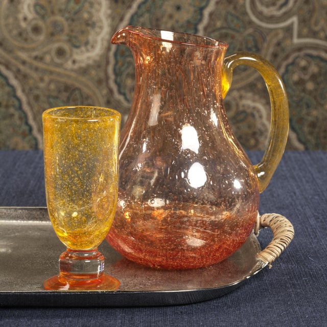 Designed to bring warmth and vibrancy to any setting, the Antibes Glass Pitcher features a delicate bubble effect that...