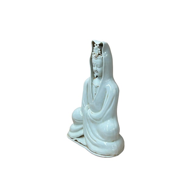 Embrace tranquility with this captivating Dehua Blanc de Chine porcelain statue depicting Guanyin, the Buddhist...