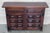 From Spain, constructed of solid walnut, the rectangular top without edge top, conforming case housing two carved drawers...