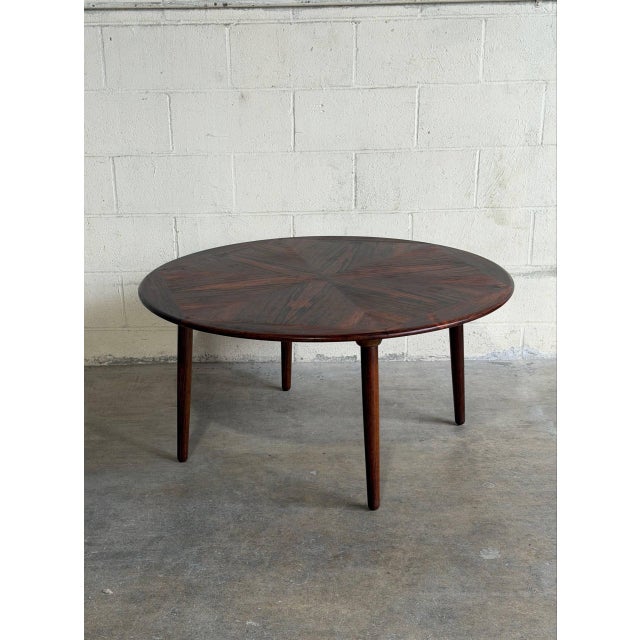 Beautiful vintage Danish modern coffee table in style of H.W. Klein, crafted in richly grained rosewood with an...