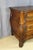A Lyon-style walnut commode with a curved front, opening with three drawers, including a secret drawer in the top drawer....