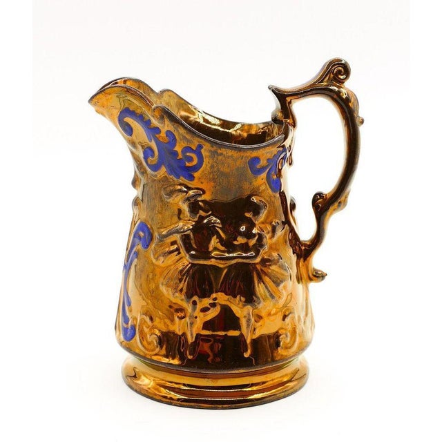 This GoldStone Jug is a decorative object realized in England at the end of the 19th century. It is a porcelain jug...