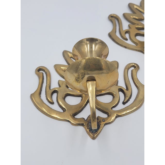 Elevate your space with this striking pair of vintage mid-century solid brass wall sconces, showcasing a beautiful blend...
