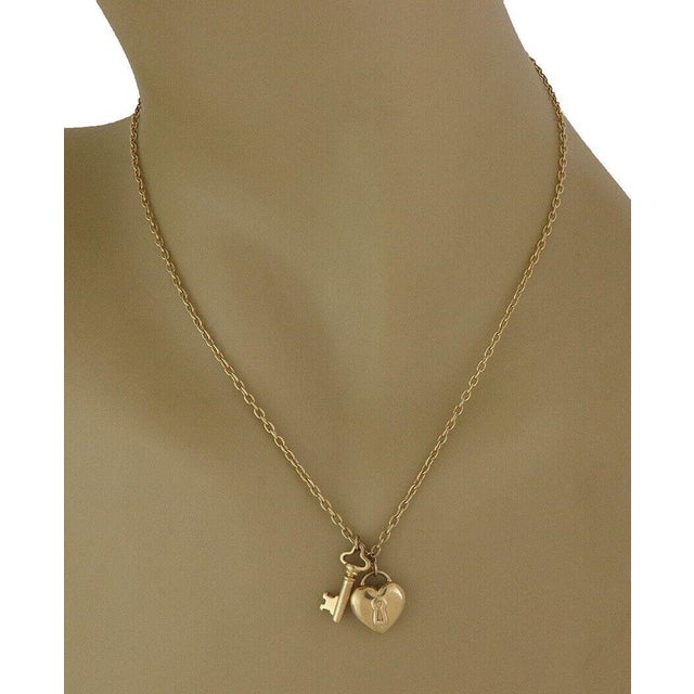 This is an authentic Tiffany & Co. necklace; it is crafted in 18k yellow gold with a fine polished finish. The pendant is...