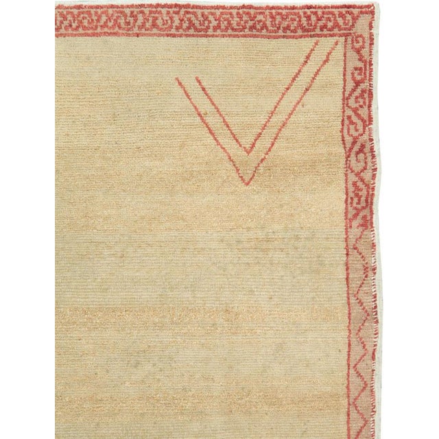 This mid-20th-century Turkish Anatolian gallery rug presents an exceptionally restrained composition centered on a broad,...