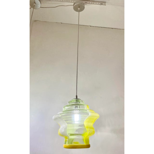 Fun and elegant Italian contemporary custom-made pendant chandelier, of organic modern design, entirely handcrafted with...