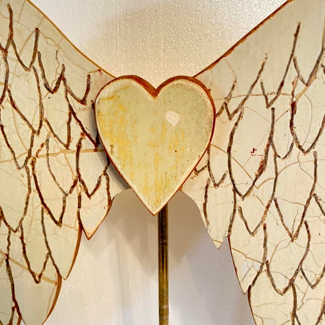 Carved Angel wings with a carved heart made from Antique wood and mounted on an old lamp base. One of a kind art by Folk...