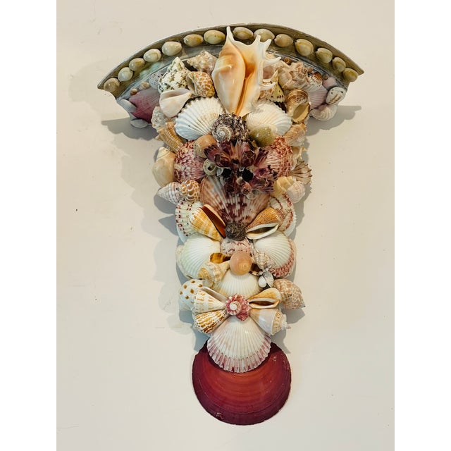 Gorgeous pair of sea shells encrusted wall brackets with birds nest white coral branches.