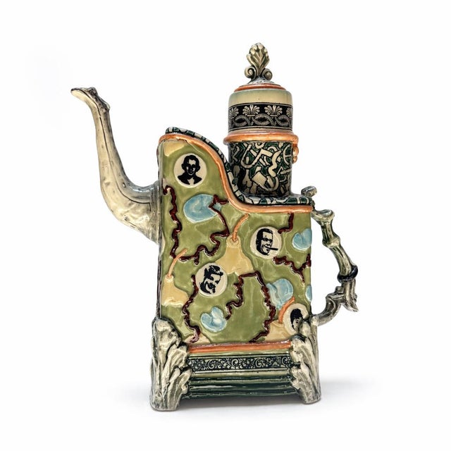 Green Large Teapot with Faces and Elephant Spout is a whimsical celebration of storytelling through ceramics, transforming...