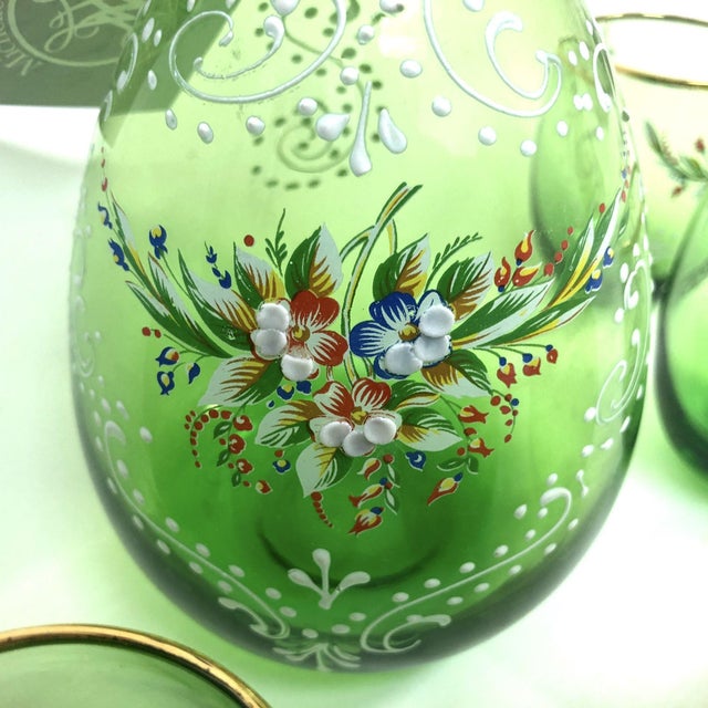 A stunning vintage Bohemian cordial set featuring one hand-blown decanter and six matching glasses in luminous Venetian...