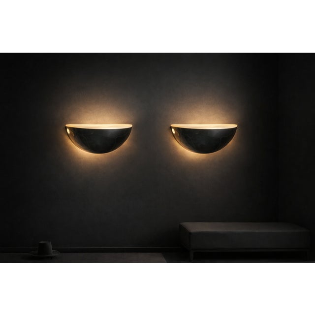 The brass "Quarto Wall Lamps" are a design icon. Introduced in 1973, they remain a highly regarded design element for...