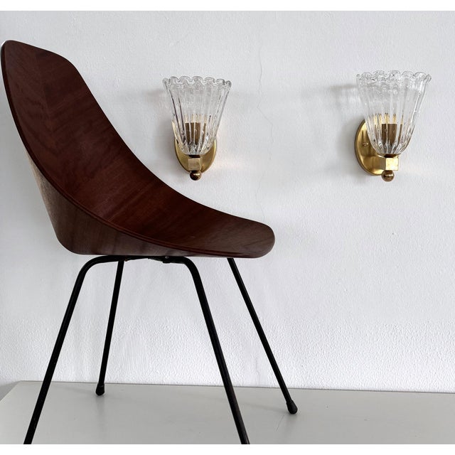 Set of two wall lamps made of transparent thick Murano glasses with small air bubbles inside the glass and strong brass...