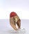 This impressive vintage cocktail ring showcases a large oval cabochon of rich Mediterranean coral, its deep warm orange...