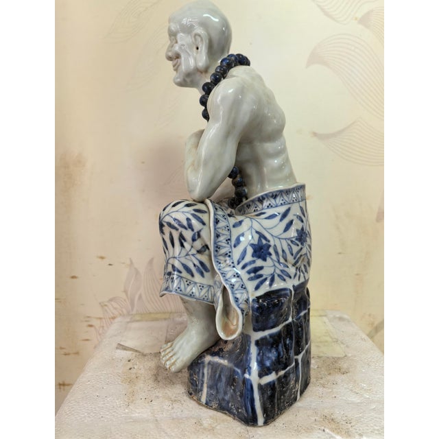 W-23cm,H-31cm This hand-carved blue and white porcelain statue depicts The Eighteen Arhats, a traditional Chinese Buddhist...