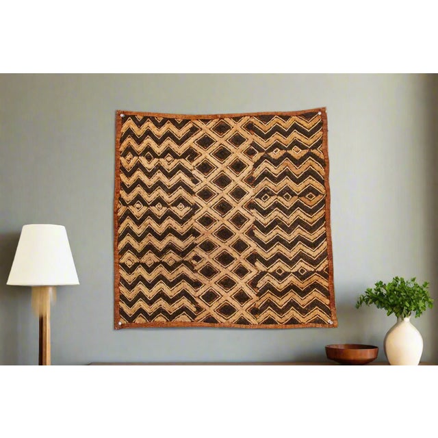A captivating masterpiece of African textile art, this vintage Kuba cloth panel is a testament to the unparalleled...