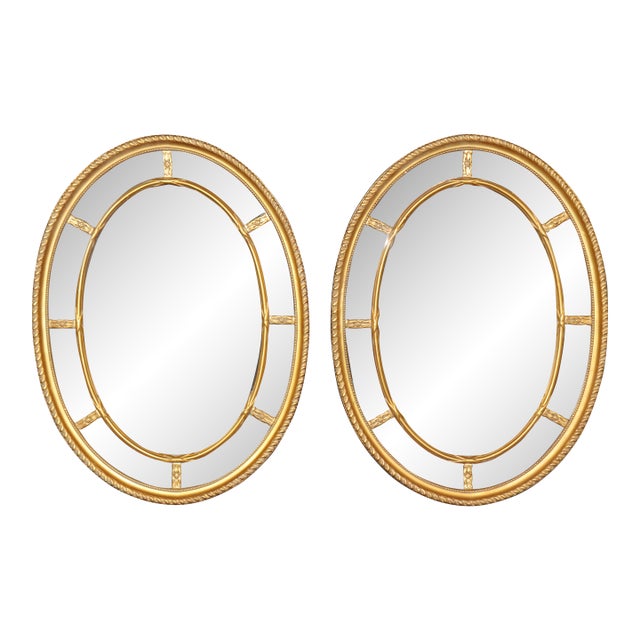 Pair of Beveled Glass Oval Neoclassical Style Gilded Mirrors For Sale