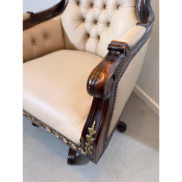 An elegant antique Empire-style swivel desk chair, beautifully crafted from solid mahogany with hand-carved gilt accents...