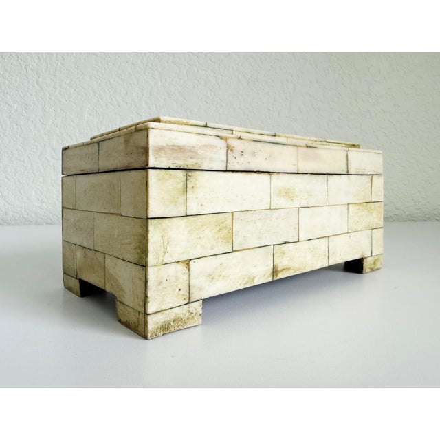 A vintage late 20th-century handcrafted bone inlay decorative box. It features hand-cut rectangular tiles crafted from...