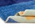 Sea, sky, and a single sun: a modern horizon, drawn in bold bands of color. Three wide horizontal fields divide the rug...
