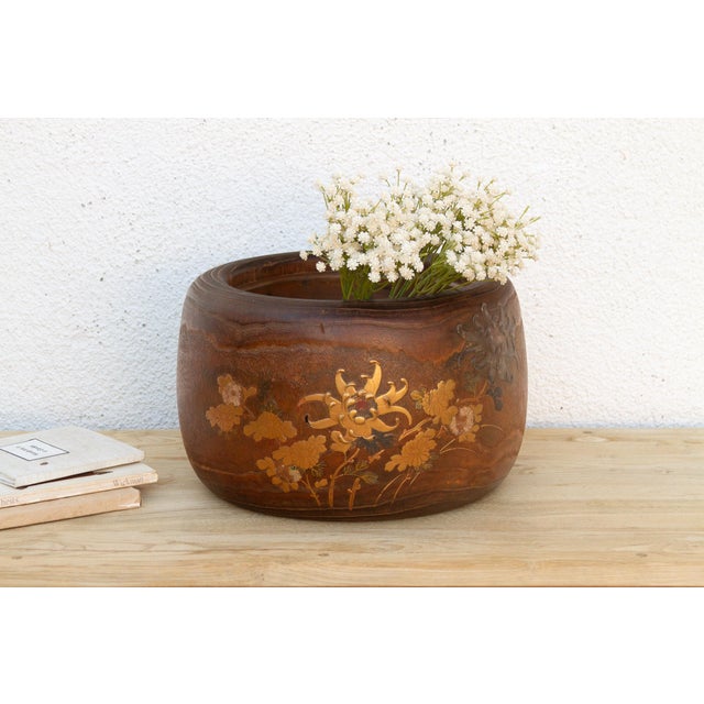 Turn this one slowly and the decoration tells a small story, a bird caught mid-flight on one side, a flowering branch...