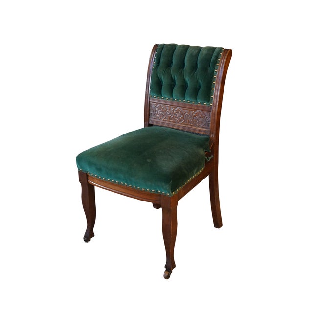 This late Victorian Eastlake-style chair features a rich mahogany frame detailed with a distinctively carved geometric...